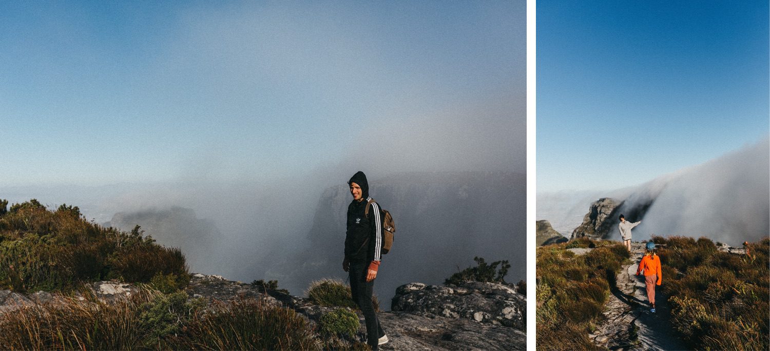Zwei Fotos einer talentierten Fotografin: Links steht eine Person in einem schwarzen Kapuzenpulli auf einem felsigen, nebligen Bergpfad; rechts gehen zwei Wanderer unter einem klaren blauen Himmel mit Nebel. Eingefangen mit einem Auge für Abenteuer im Fotostudio Köln.
